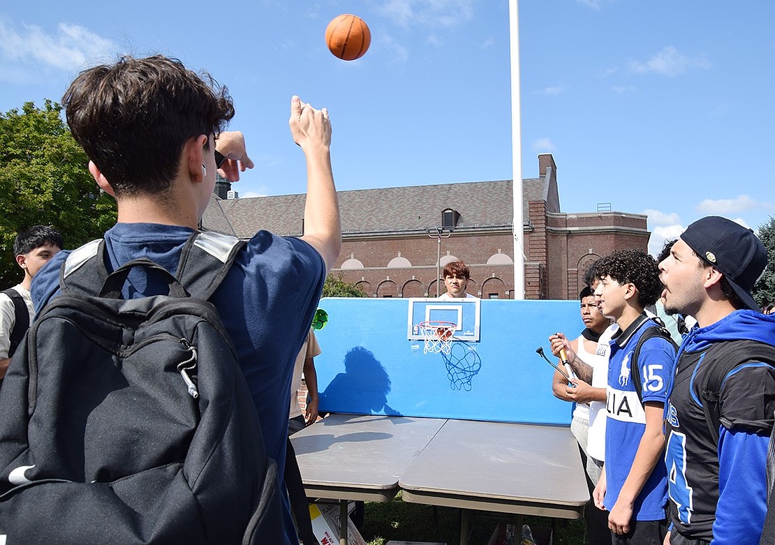 Dominic Piria, a sophomore, sinks three baskets in a row to earn an inflatable beach ball.