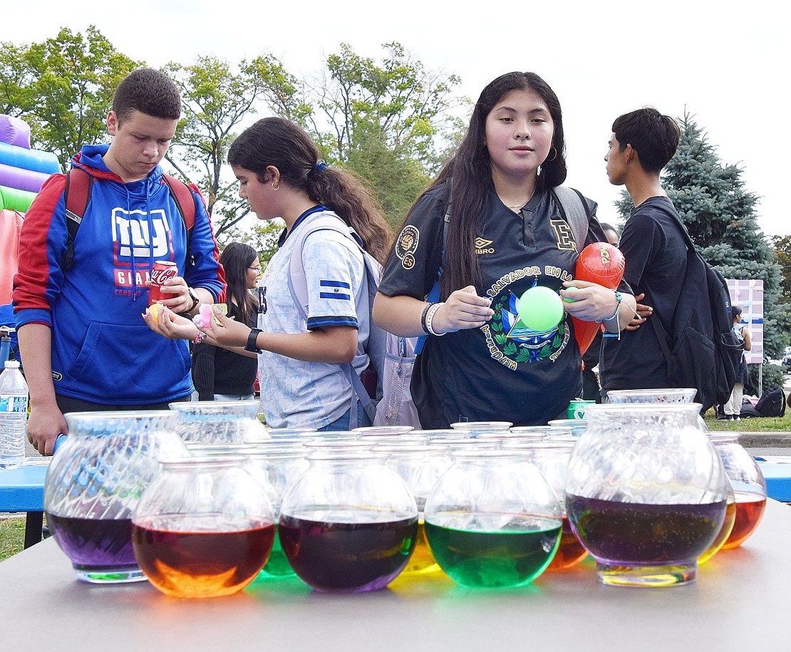 Park Avenue resident Kerry Hernandez, a Port Chester High School freshman, hopes her bouncing ping pong ball lands in one of the small fish bowls at the game booth set up at the school’s annual Ramily Carnival on Friday, Sept. 20. Hundreds attended the event to play games, eat food and sign up for clubs.