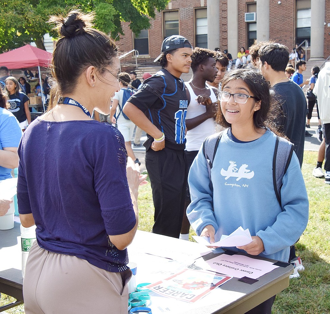 Bilingual math teacher Katherine Daly-Robertson discusses the Career Cruisers Club with freshman Naiah Talatay, who lives on Westchester Avenue.