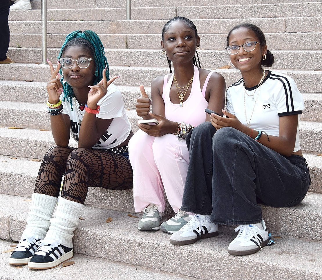 Sitting on the steps in front of the high school, sophomores Swayda Hunter, Dynasti O’Neil and Faith Adamson pose for the camera.