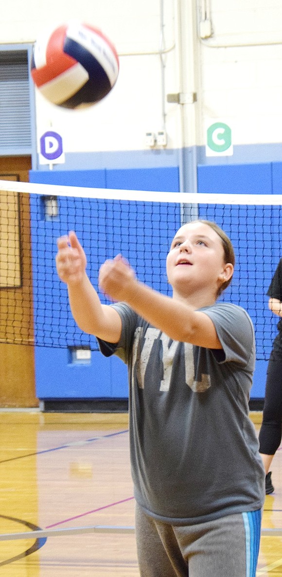 Keeping her eye on the ball, sixth-grader Michaela Meiri practices her bumping skills.