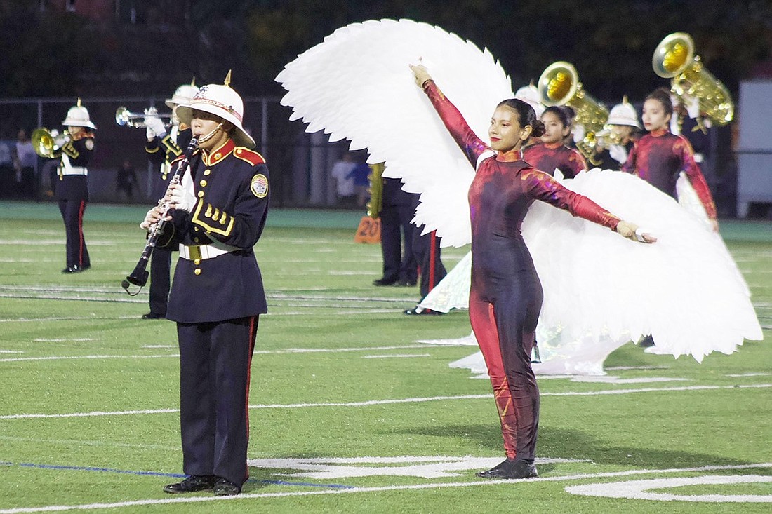 The Port Chester High School Marching Band soars while performing their “Flight of Fire” field show during a competition.