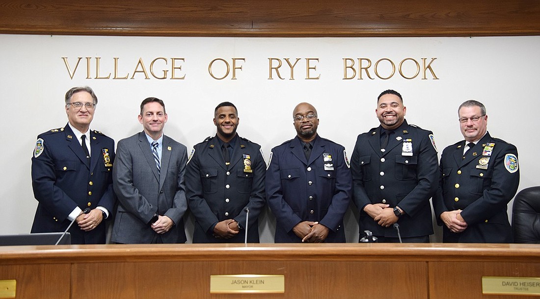 Rye Brook Police Chief Greg Austin (left) and Lieutenant John Arnold flank four officers who were honored with police awards at the Board of Trustees meeting on Sept. 24: Detective Marc Rampolla, Detective Orelvis Lazala, Officer Elliot Asare and Officer Abel Taveras. Two other officials, Sergeant Daniel Bruno and Officer David Cryeski, were honored that night but were not present.