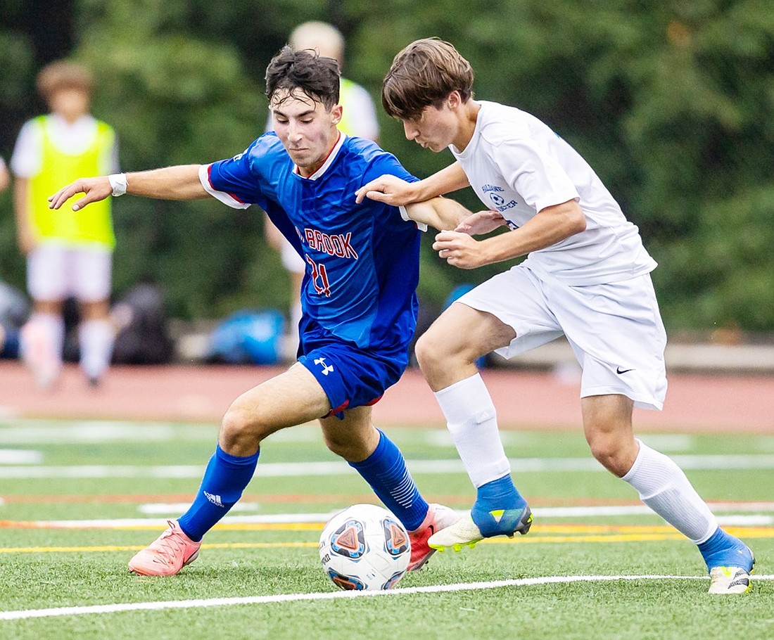 Junior Noah Becher is in a footrace with a Haldane defender for possession in Blind Brook’s Monday, Sept. 23 home game against the Blue Devils.