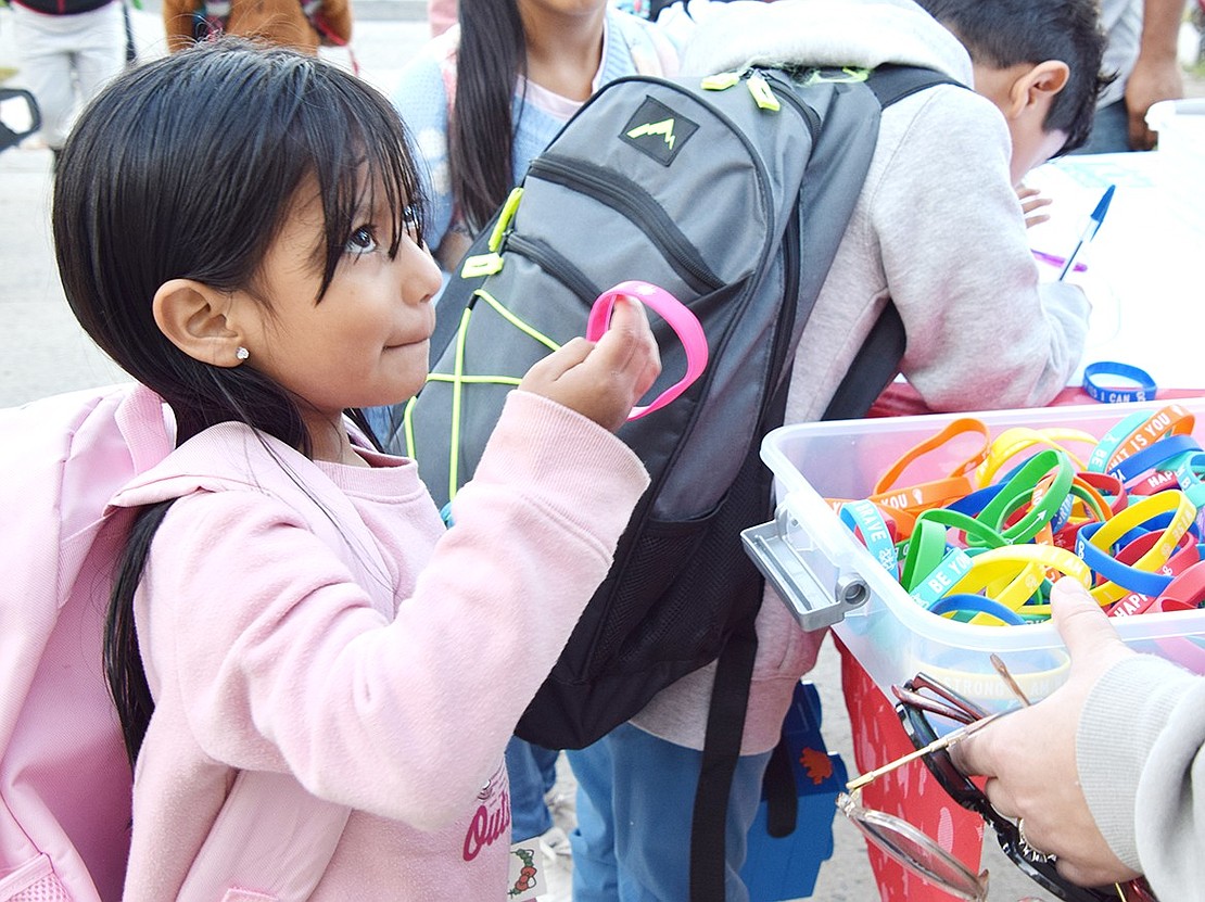 Irving Avenue resident Alison Garcia, 5, selects a bracelet as her reward for walking to Park Avenue School that morning.