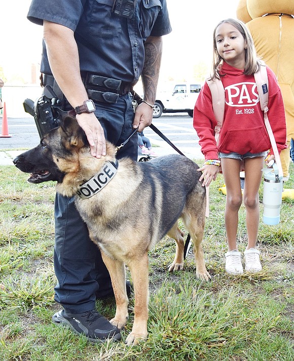 After being told to keep her hands away from his face, Park Avenue School second-grader Sophia Pirrone, 7, cautiously pets Port Chester police K9 Officer Mac.