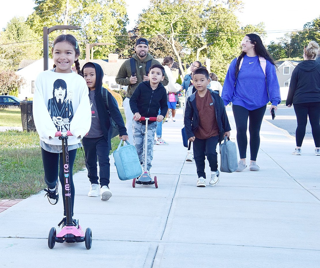 Second-grader Sydney Iglesias, 7, cruises ahead of her family on her way to King Street School on Tuesday, Oct. 8, to celebrate International Walk to School Day. Park Avenue School students did the same on Wednesday, Oct. 2. Both celebrations offered photo-ops with mascots, music and a way to spend the morning with family and friends.