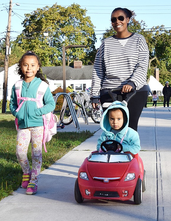 King Street School kindergartener Lucie Cadek (left), a 5-year-old who lives on Shelley Avenue, walks alongside her 2-year-old brother Jakub as their mom Sheena pushes him along.