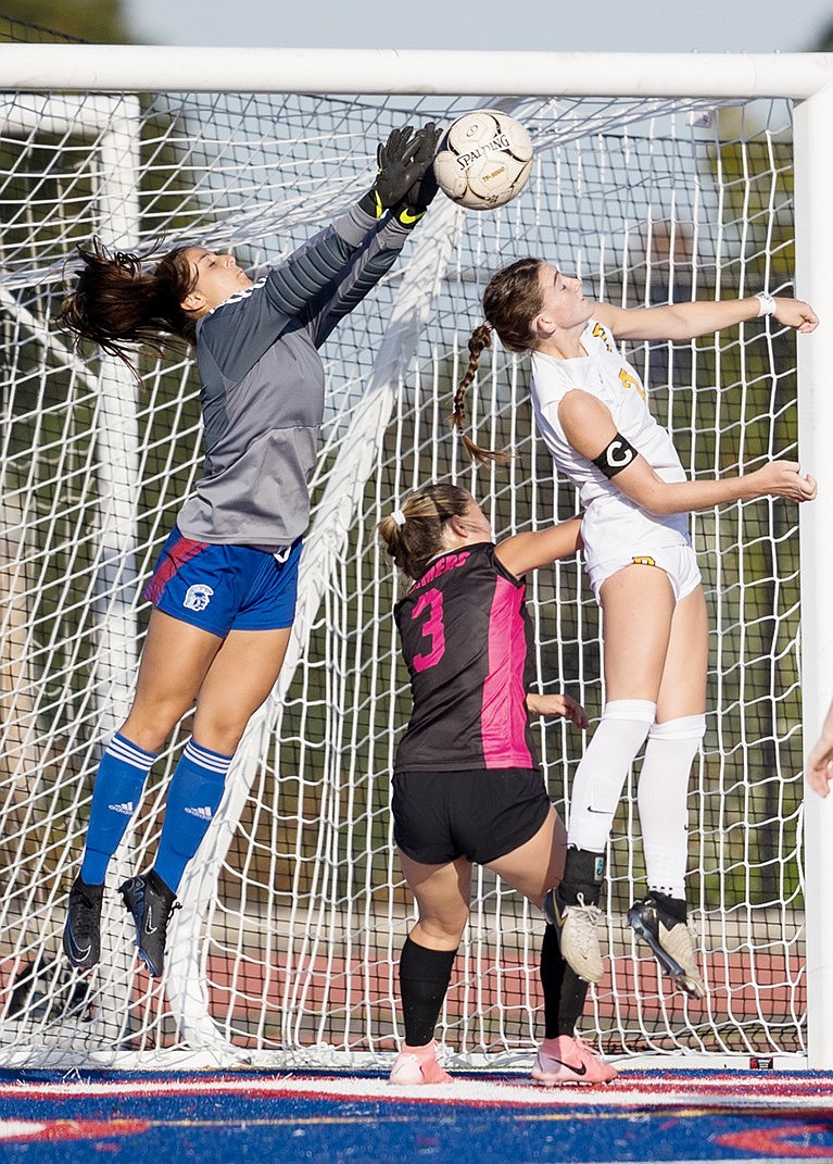 Goalkeeper junior Bella Montesano makes a great save on an attempt by a Pelham opponent in a home matchup on Tuesday, Oct. 1. The Trojans lost that game to a larger school in a higher class by only one point.