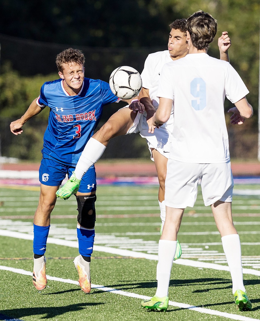 Senior Danny Keilman attacks the ball, fighting against two Westlake players in Blind Brook’s Saturday, Oct. 5 home victory by a score of 3-2.