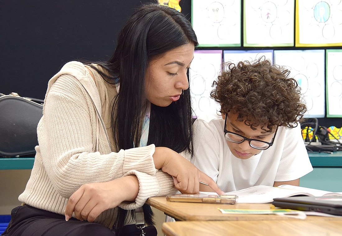 Teaching Assistant Jessica Espinoza helps John F. Kennedy Elementary School fourth-grader Alvin Buten with a homework assignment at the afterschool program on Sept. 30. Facilitated by the Carver Center, the afterschool program is being offered to Port Chester Schools families for $100 a year, a drastic decrease compared to last year which has subsequently led to a spike in enrollment.