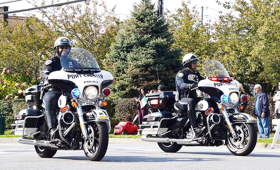 Port Chester police officers ride past Veterans’ Memorial Park as they escort the parade through the Village.