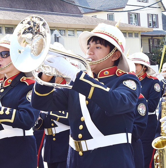 Austin Nij, a Port Chester High School junior, steps out of his usual role of drum major to play the mellophone with the marching band.