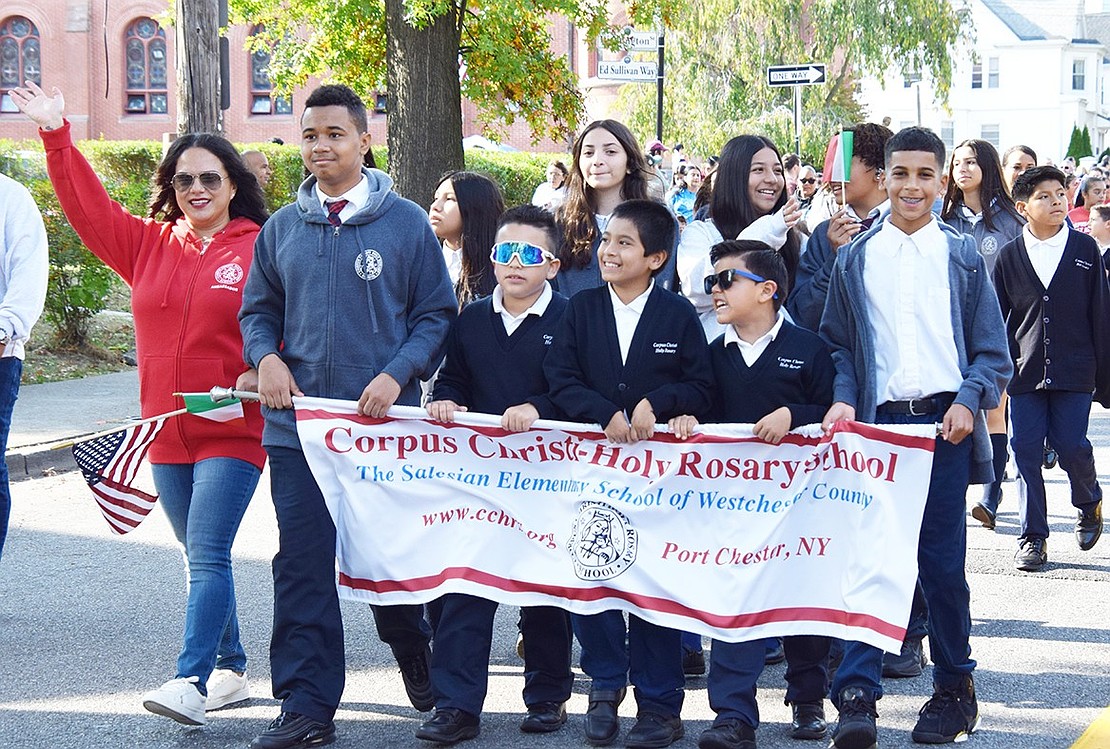 A group of Corpus Christi-Holy Rosary School students smile widely as they represent their school at the event.