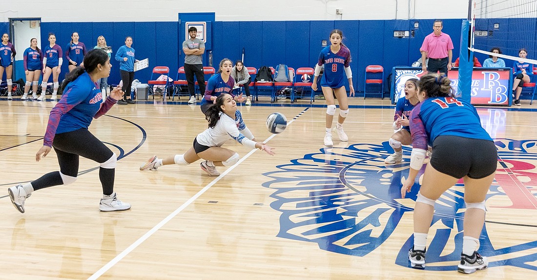 Senior libero Maria Gracia Leyva-Pereyra digs the ball as teammates watch in excited anticipation during Blind Brook’s Tuesday, Oct. 15 home game against higher class competitor Byram Hills whom the Trojans beat nonetheless 3-2.