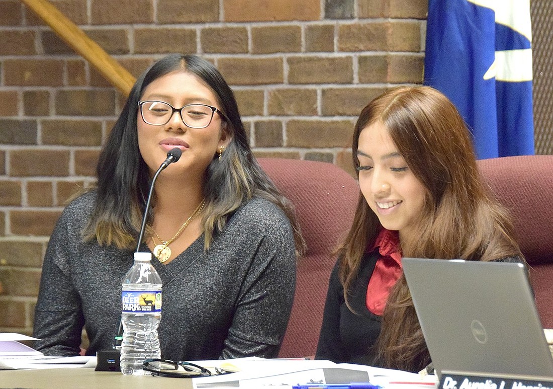 Port Chester High School junior Sheyly Poroj (left) and senior Katherine Balbin introduce themselves at the Board of Education meeting on Oct. 17. Months before a state law goes into effect, mandating that Boards of Education appoint student members, the district takes a step in that direction by appointing Poroj and Balbin as liaisons.