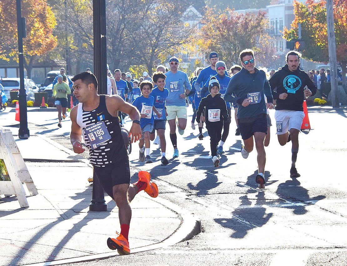 Following their route, runners collectively turn onto North Main Street during the 4th annual Meals on Main Street 5K & Fun Run on Sunday, Oct. 20. The event saw 483 people participate to raise funds and awareness for the organization’s mission to distribute food to those in need.