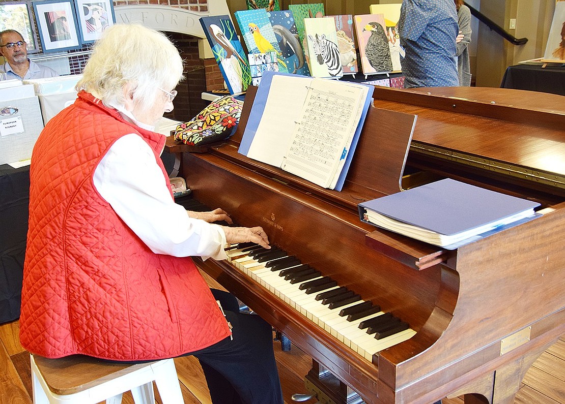 Rye resident Donna Cribari sets the mood by playing classical music on the piano.