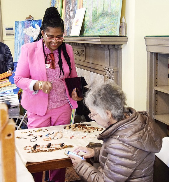 Barber Place resident Totlyn Jackson buys some handmade jewelry from Port Chester resident Nora Freeman.