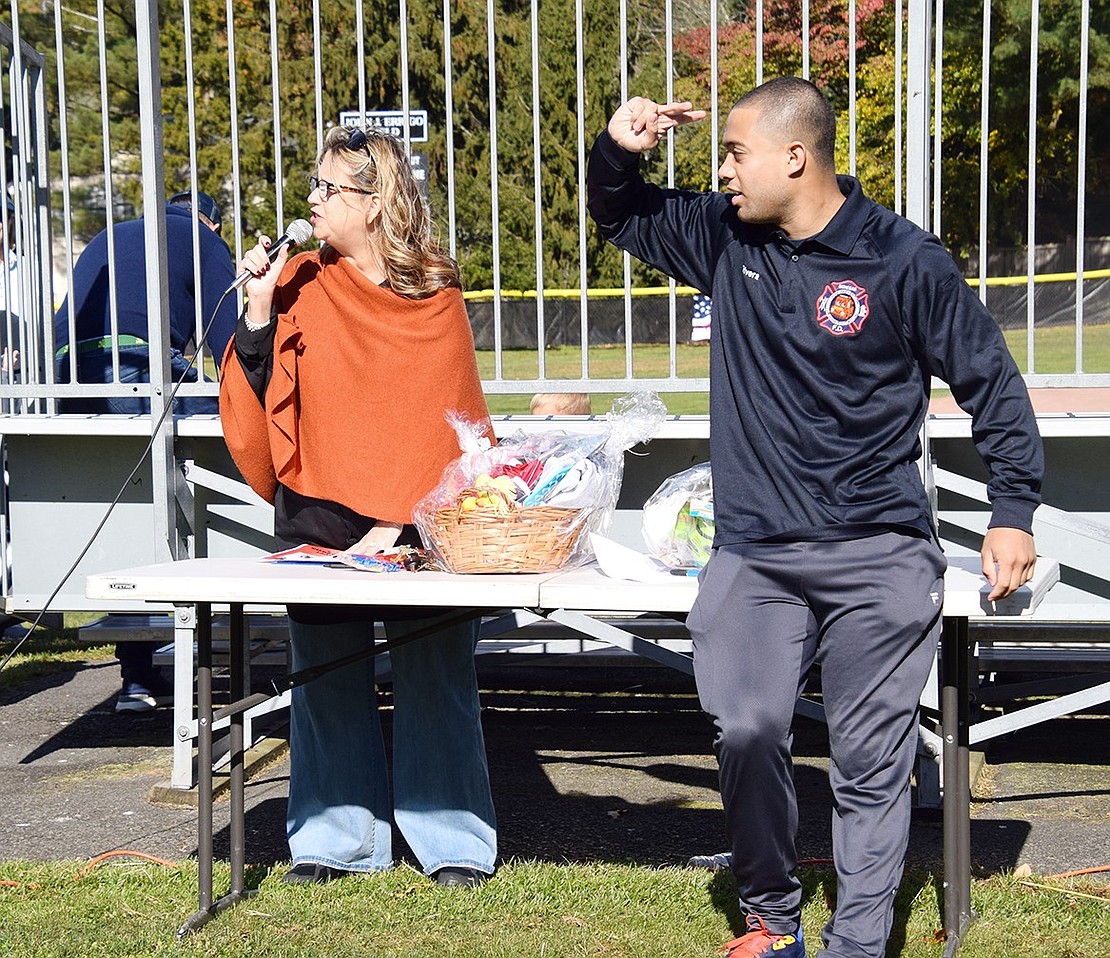 Announcing the dogs before they strut through the park, Rye Brook Senior Coordinator Liz Rotfeld emcees the costume contest with the help of Assistant to the Village Administrator Greg Rivera.