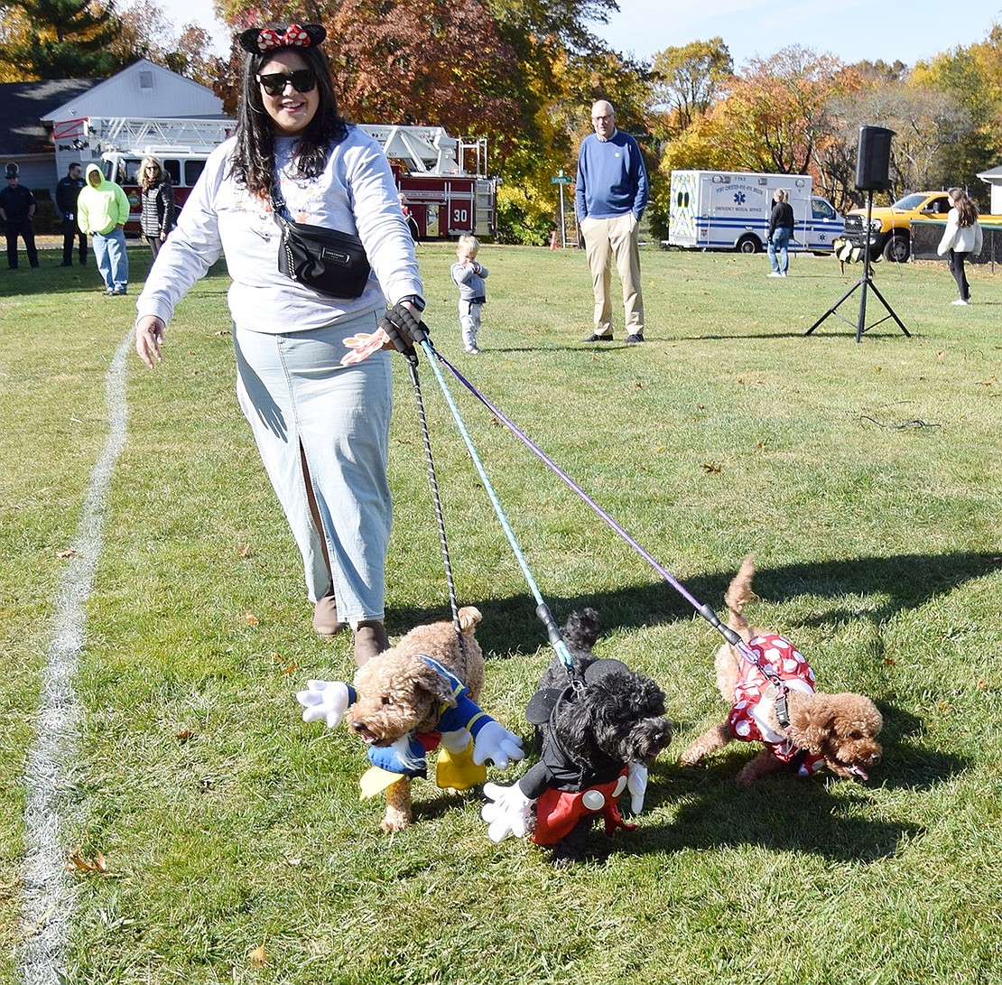 Harrison resident Liliana Lopez walks her dynamic classic Disney trio through the contest lap. The mini-poodles Zeus, Tutu and Maia are dressed as Donald Duck, Micky Mouse and Minnie Mouse.