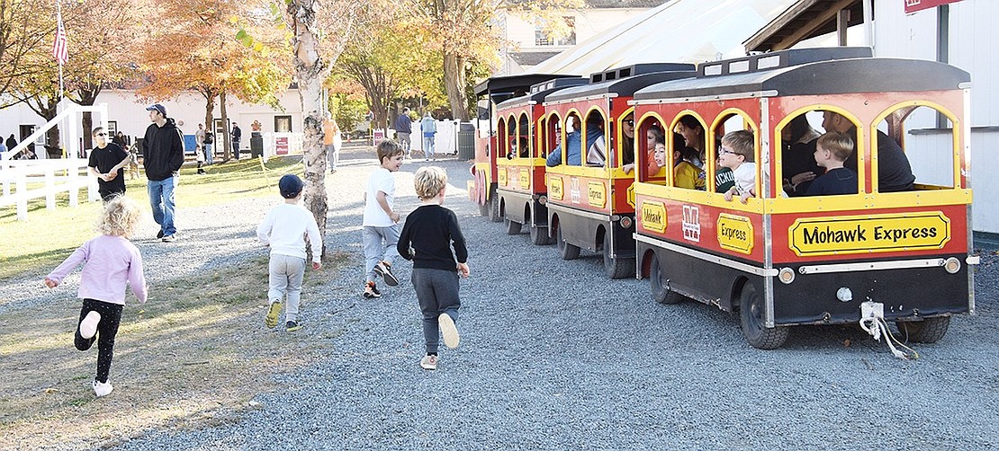 A group of children chase after their friends taking a lap around the campground on the Mohawk Express.