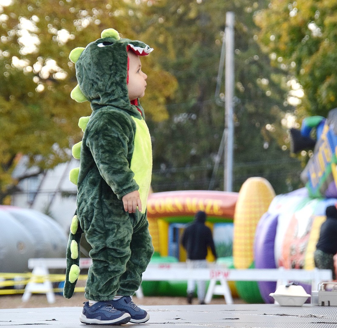 Lincoln Scherer, a 19-month-old T-rex from Greenwich, Conn., makes it a point to walk across the costume contest stage all by himself.