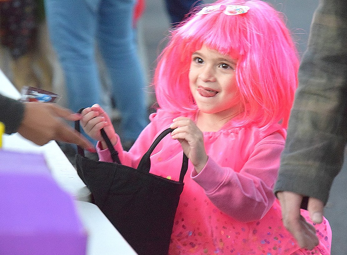 Dressed as a hot pink cupcake, Elizabeth Street resident Vivianne Sprovieri, 4, looks for a snack just as sweet as her costume while walking through the trick or treat line at the Village of Port Chester’s annual Halloween in the Park event at Lyon Park on Monday, Oct. 28.