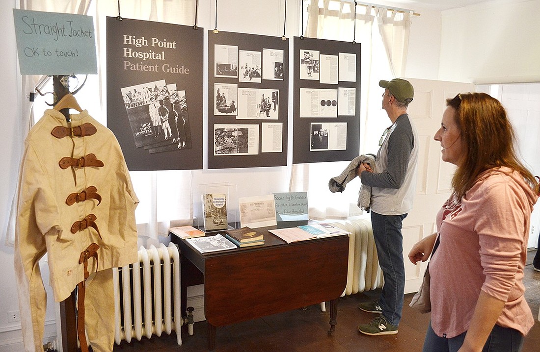 Jodi and Bryan Wolkind, BelleFair residents who have been anxious to learn about High Point Hospital for years, check out a section of an exhibit about the old mental institution dedicated to Dr. Andrew Gralnick’s philosophy of treatment. The exhibit at the Bush-Lyon Homestead in Lyon Park was co-curated by the Port Chester Historical Society and documentary filmmaker Jill Yesko and will be available to view through November.