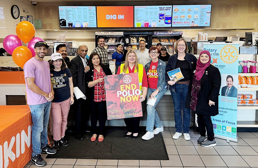 Polio Plus Committee, from left, Kenneth Karas, Stacy Karas, Syed Alirahi, Mahbub Ahmad, Bina Ahmad, Michele Thomas, Barbara Hanna, Ruth Walker, Shazia Alirahi). Port Chester Dunkin Donuts owners and staff stand in the background. Missing: Eric Storberg.