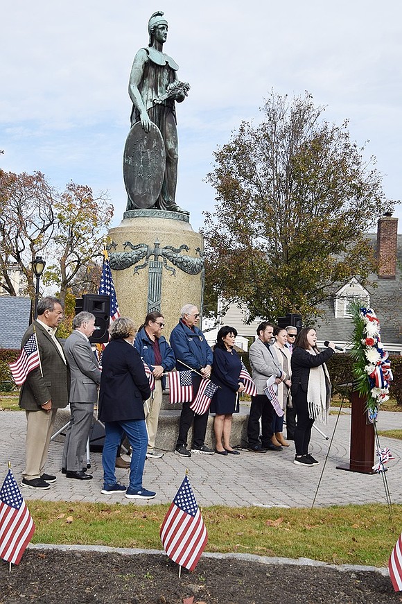 Port Chester native Kim Maguire sings “America the Beautiful.” She is surrounded by local, county and state officials, from left, Nancy Barr, George Latimer, Steve Otis, Carla Pugliese (hidden), Tom Nardi, Gary Zuckerman, Hope Vespia, Phil Dorazio, Juliana Alzate and Deacon Mike Izzo.