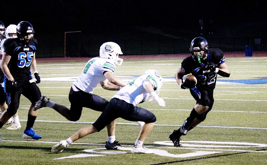 Carmine Casino runs the ball past Irvington defenders in the Blind Brook/Edgemont season-opening game on Sept. 6 at Edgemont.