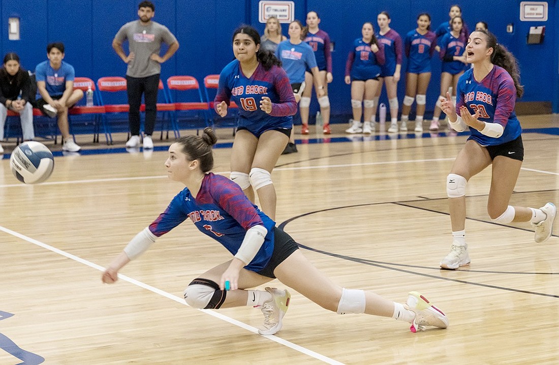 Sophomore Georgie Haas dives to pass the ball as her teammates behind her anxiously await her impending success in Blind Brook’s Wednesday, Nov. 6 sectional semifinal game against Putnam Valley. It was an exciting home match that ended in a 3-2 victory for the Trojans.