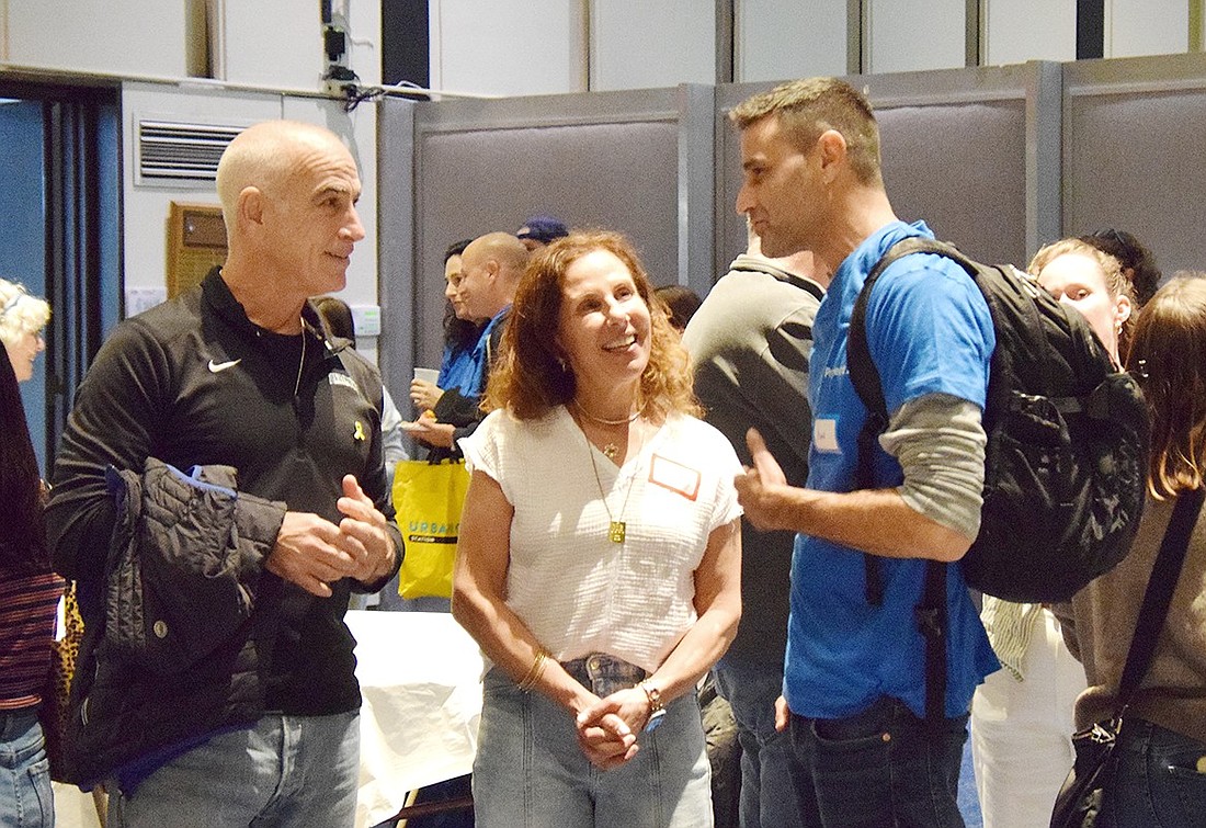 Gregg Bienstock (left), a volunteer with Walk for Their Lives, and Rye Brook resident Hanna Poplausky speak with Kibbutz Gevim Emergency Team member Amir Ashkenazi on Monday, Nov. 11. Ashkenazi and his family were some of the 56 Israelis invited to Westchester by local synagogues including Congregation KTI through Project 24, offering them days away from the Israel-Hamas War.