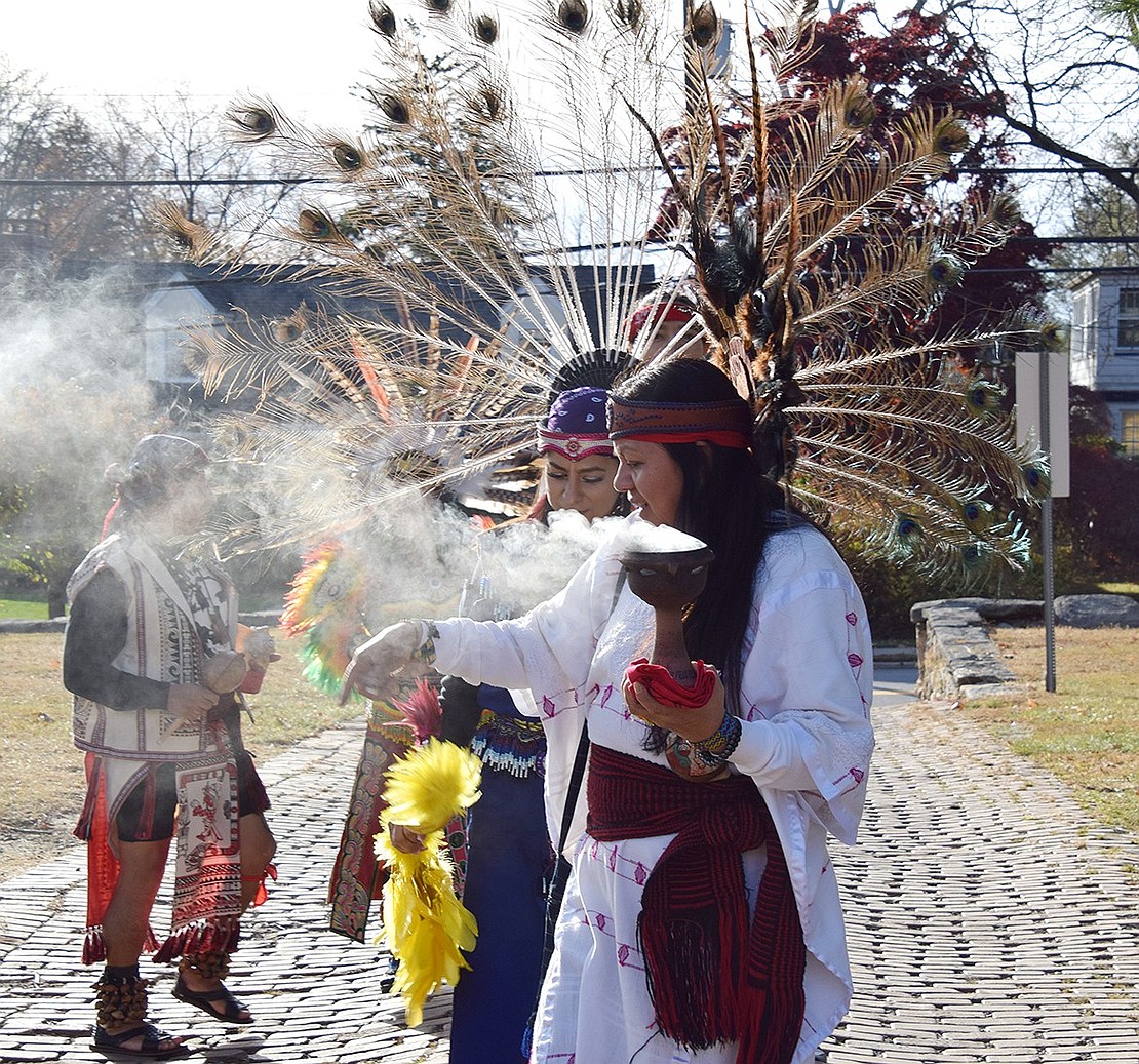 Lily Rojas, a Queens resident, burns incense in preparation for her Aztec dance with La Santa Cruz Del Caminante.