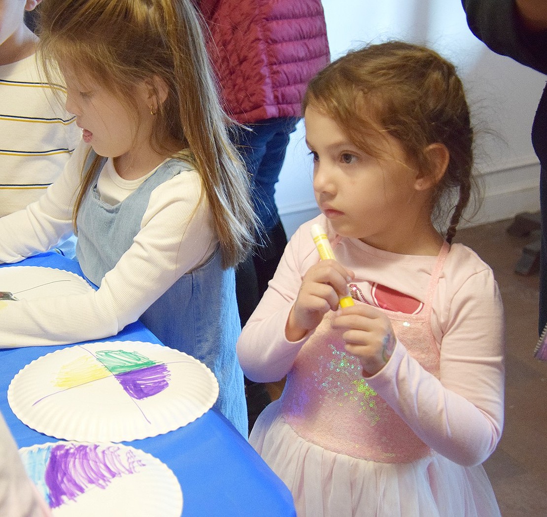 Arthur Court resident Jordan Vargas, 3, finishes with a yellow marker while making a medicine wheel, inspired by those made by the Lenape.