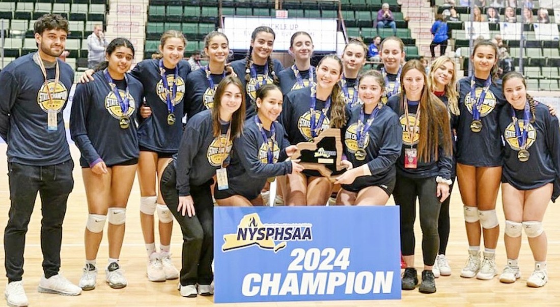 The Blind Brook High School girls’ volleyball team and their coaches pose with their plaque after winning the Class B state championship Sunday, Nov. 24 at Cool Insuring Arena in Glens Falls. Back row, from left: Assistant Coach Max Brock, Tanisha Venkatapur, Annabel Rosenfeld, Oriah Rosenfeld, Ella Rosenfeld, Holly O’Neill, Georgianna Haas, Natalie Geller, Juliana Cardillo (statistician), Gabriella Gonzalez, Hailey Baruch. Front row, from left: Assistant Coach Sam Yannuzzi, Maria Gracia Leyva Pereyra, Madeline Hirsch, Fernanda Julian, Head Coach Gina Carlone.