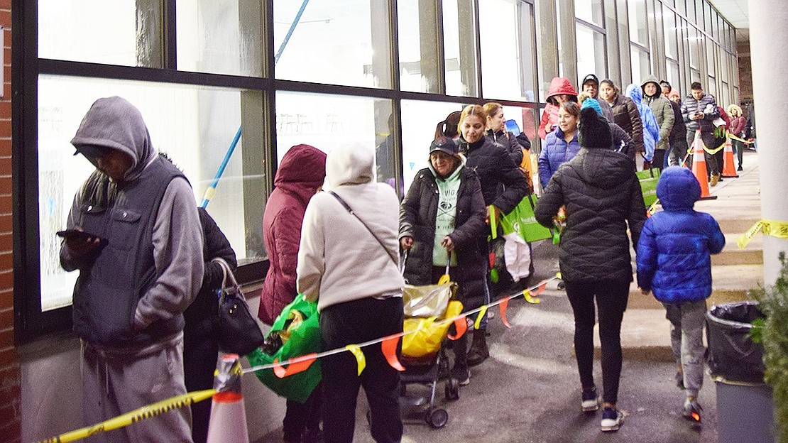 The line for the giveaway wraps around the front of the Carver Center at 400 Westchester Ave. This year, 800 households registered for the event, a 100% increase over last year’s turnout, according to Carver Center CEO Anne Bradner. Each family received enough food to host a traditional Thanksgiving meal, a grocery haul estimated to be worth $200.