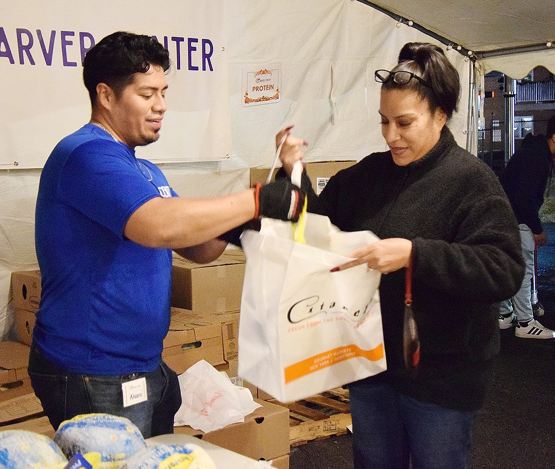 Alvaro Jimenez provides Jenny Cardona with a Thanksgiving chicken. Both are Port Chester residents.