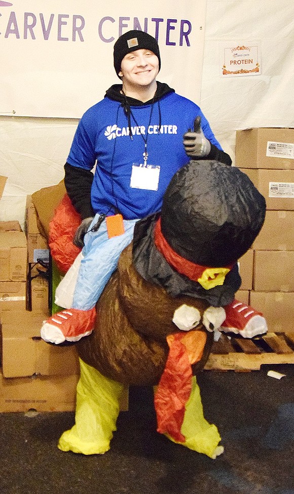 Mark Katz, the Carver Center’s individual giving manager, flashes a thumbs up while dressed in a festive inflatable turkey rider costume.