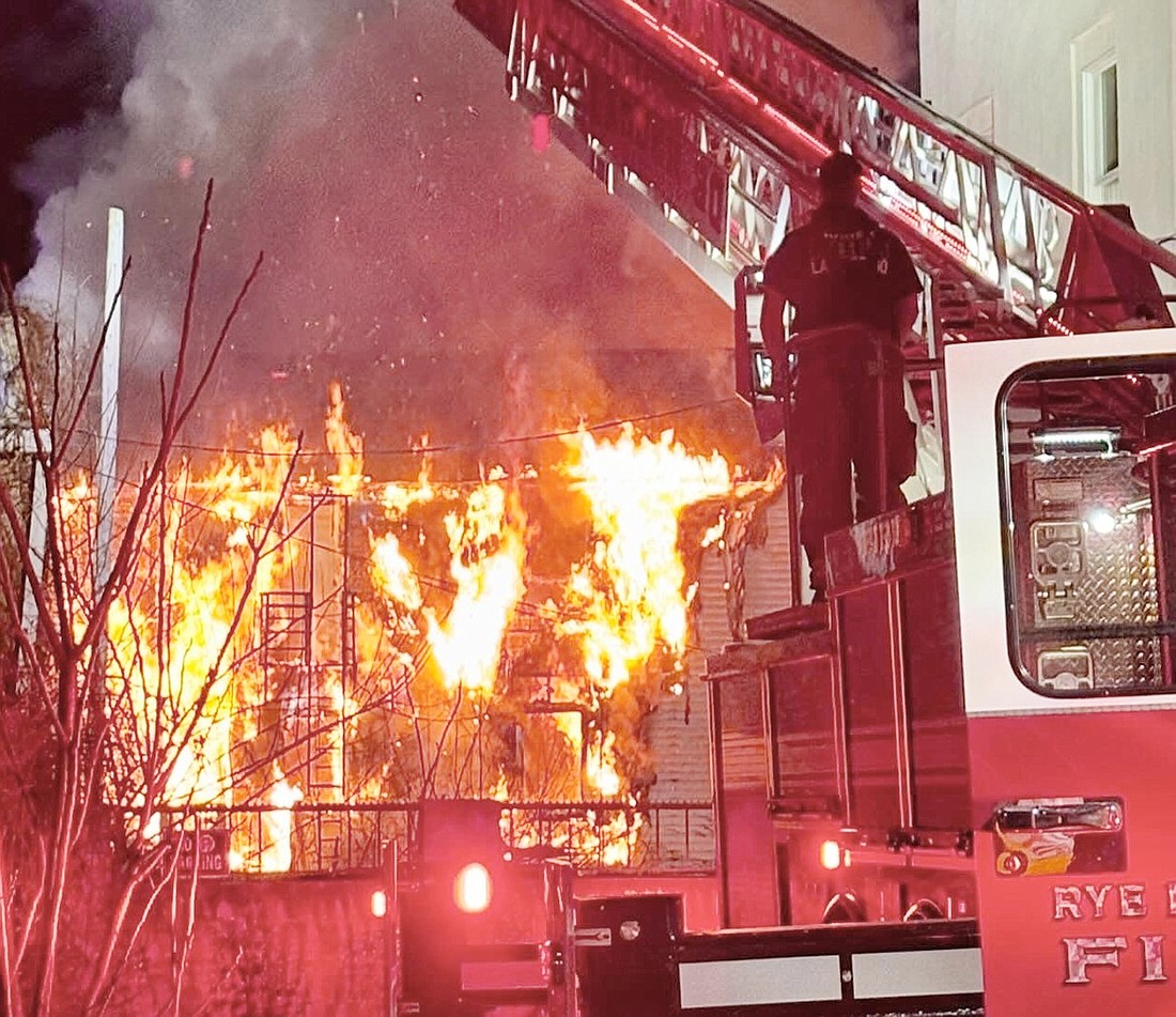 A Rye Brook Fire Department ladder truck battles a blaze at the rear of 38 Broad St. on Tuesday, Dec. 3. The Port Chester Fire Department called in support from other units for the 2-alarm fire shortly before 5 a.m.