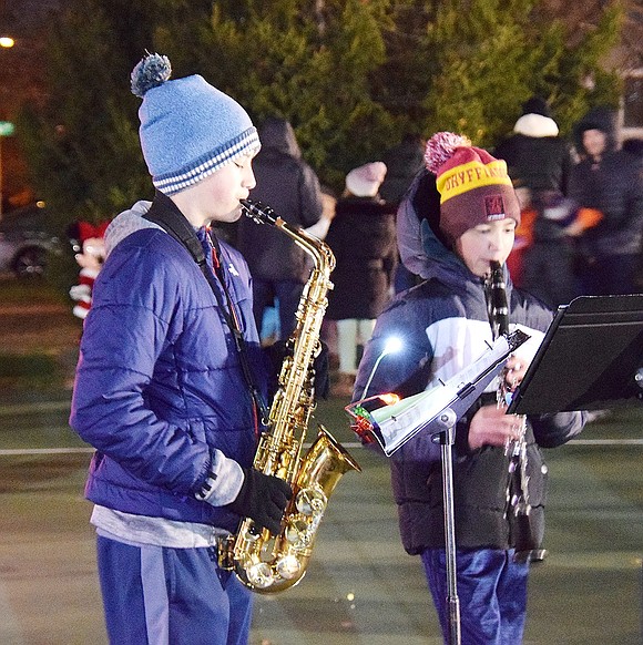 Blind Brook Middle School Band saxophonist Peter Ayala (left) and clarinetist Itamar Ferentz join their fellow musicians in a rendition of “Silent Night.”