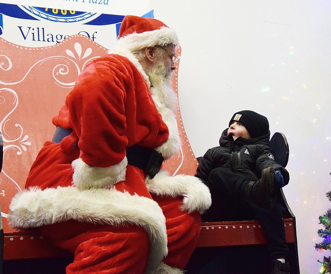 Rye Brook resident Ralph Derosa, 3, looks at Santa Claus (played by Chris Paluili of Chris and Pete Amusements) in shock and awe as he’s asked what he’d like for Christmas at the Village of Rye Brook’s annual Winterfest event on Friday, Dec. 6.