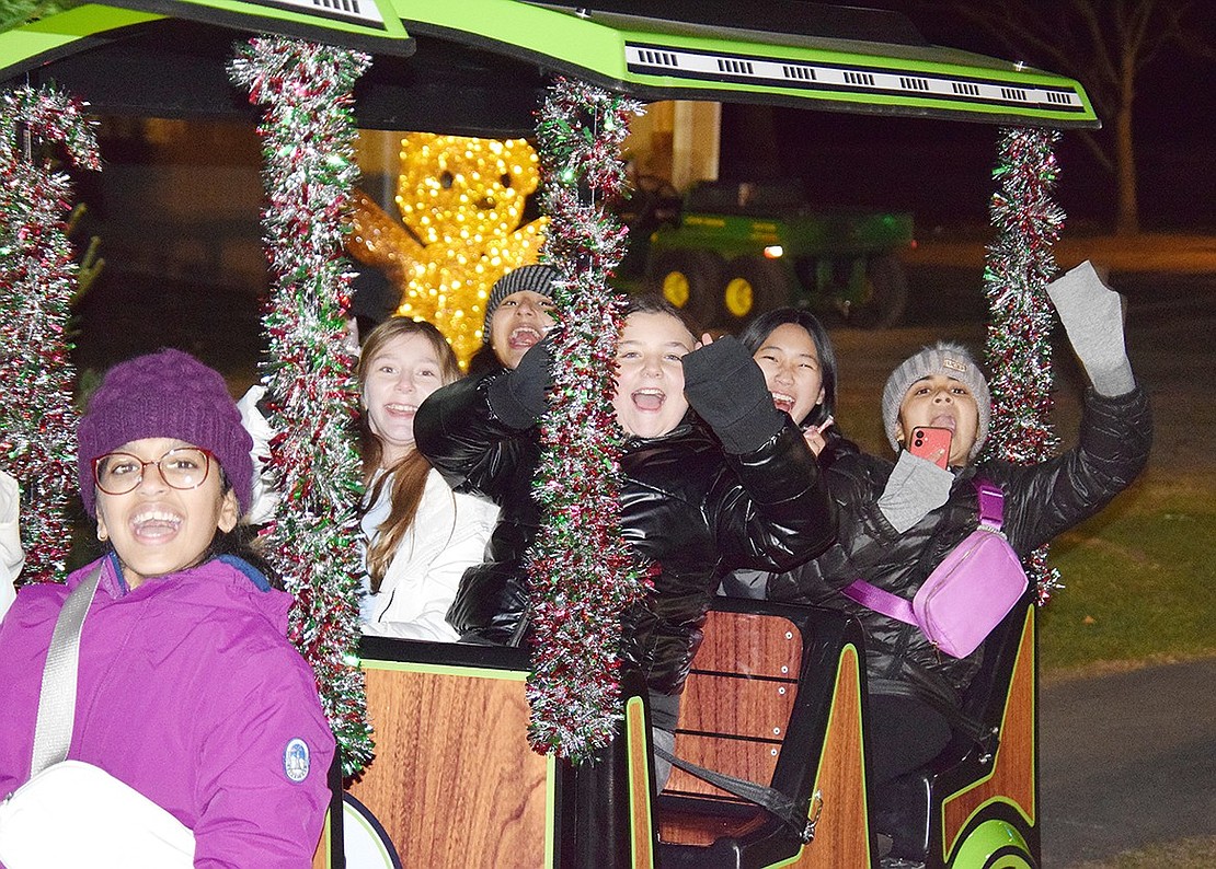 Blind Brook Middle School sixth-grader Michaella Meiri (center) and her friends excitedly cheer from the last car of the holiday train that circles around Pine Ridge Park during Rye Brook’s Winterfest on Friday, Dec. 6. Dozens of families braved the 30-degree weather to celebrate the holidays with Santa and enjoy other festive activities.