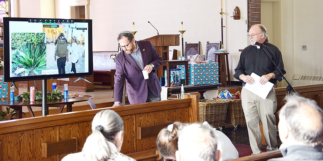 Congregation KTI Rabbi Ben Goldberg (left) and St. Paul’s Church Pastor Jim O’Hanlon present pictures of their interfaith trip to Israel to members of their combined congregations at the church at 761 King St. on Sunday, Dec. 8. Their visit to the Holy Land was designed to foster their working relationship in the community.