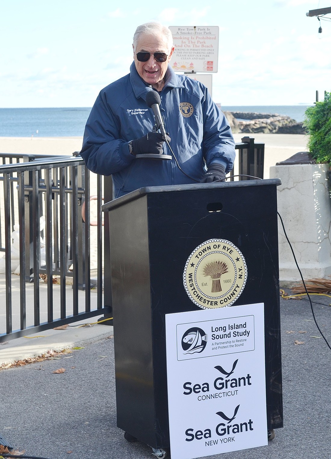 Rye Town Supervisor Gary Zuckerman speaks to the importance of communities’ addressing climate change collaboratively at Rye Town Park on Friday, Dec. 6. The Long Island Sound Resilience Planning Support Program press conference he attends announced $1.1 million in grant funding for Sound Shore communities to study causes and solutions of weather-related issues.