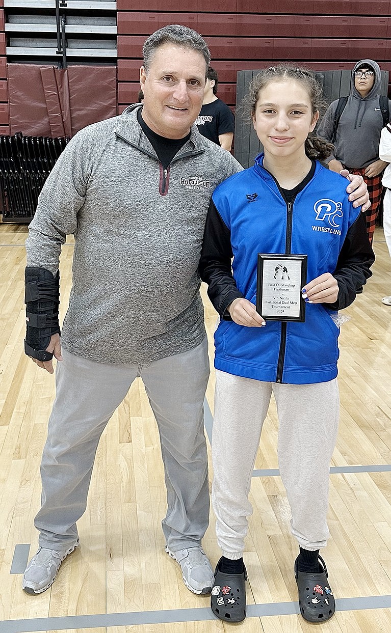 Port Chester High School lightweight Laila Builes went 5-0 at the Vin Nicita Invitational Dual Meet Tournament on Saturday, Dec. 7 in Harrison and was voted tourney freshman Most Outstanding Wrestler. She poses here with Vin Nicita, the former Harrison wrestling coach for whom the tournament is named.