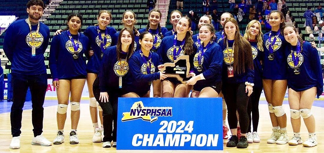 The Blind Brook High School girls’ volleyball team and their coaches pose with their plaque after winning the Class B state championship Nov. 24 at Cool Insuring Arena in Glens Falls. It was the first time a Blind Brook girls’ varsity athletic team has won a state championship.