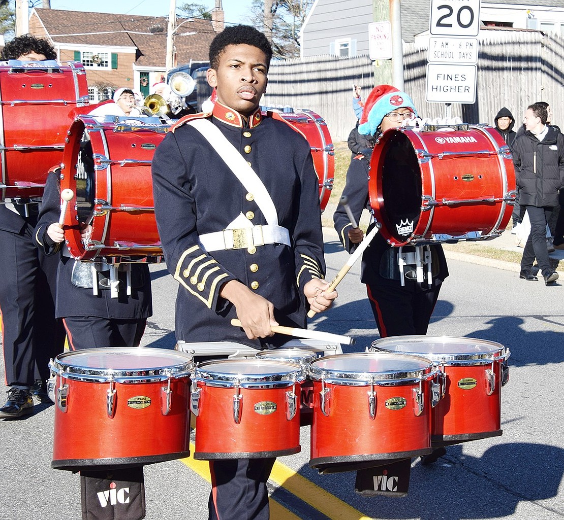 Menelik Reason, a junior at Port Chester High School, plays the tenor drums during the parade.