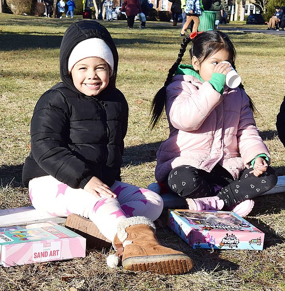 Edison Elementary School kindergartner Luna Perez (left) takes a break with her classmate Alisson Rojas to enjoy some hot chocolate.